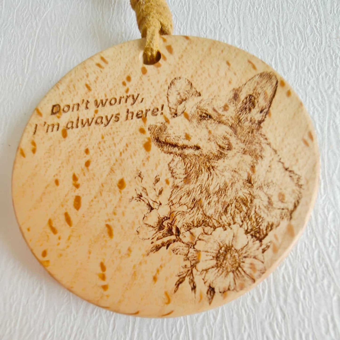 Close-up of the Corgi love design on the wooden pendant with inspirational quote.
