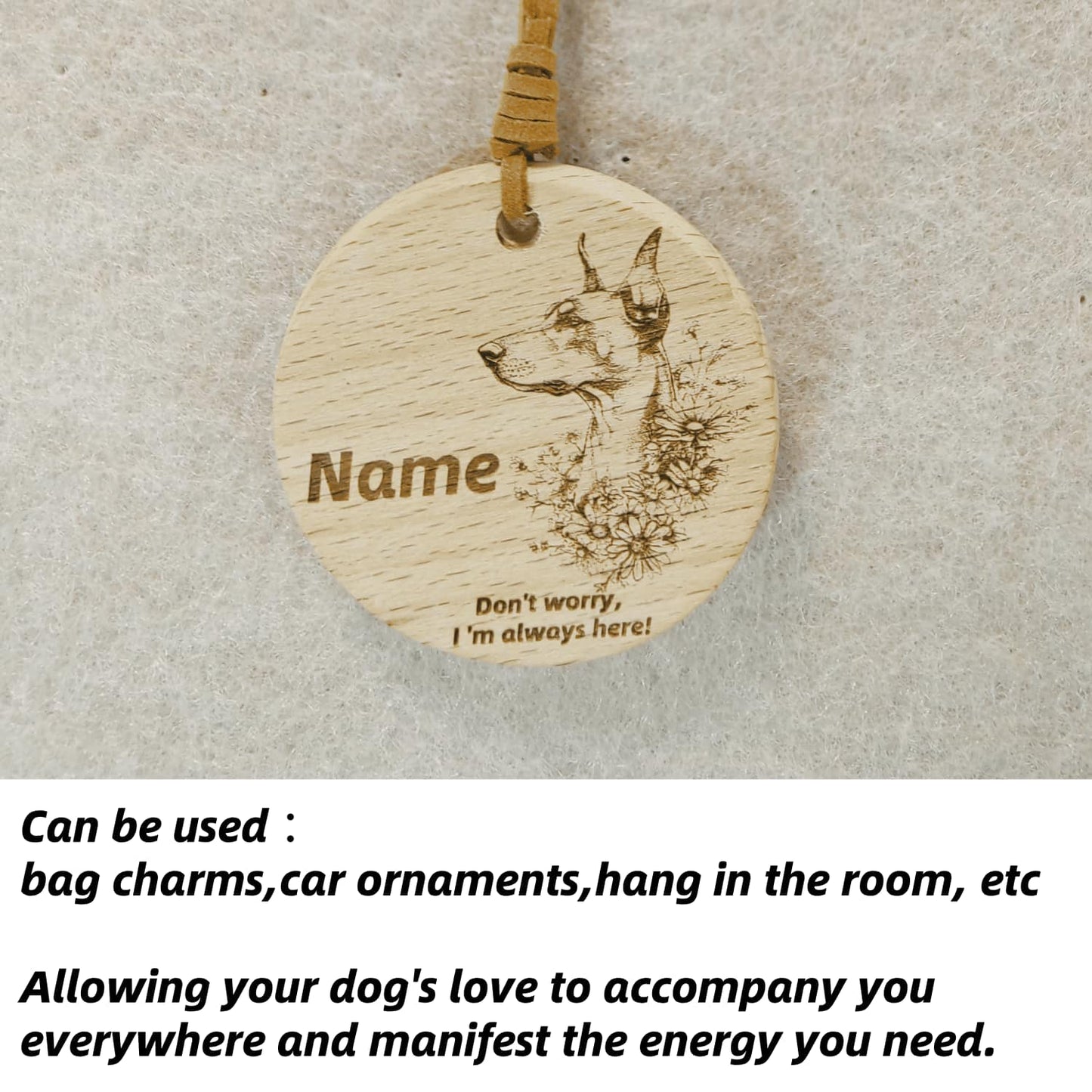 Doberman Pinscher wooden pendant used as a [car hang/bag charm] in a lifestyle setting.