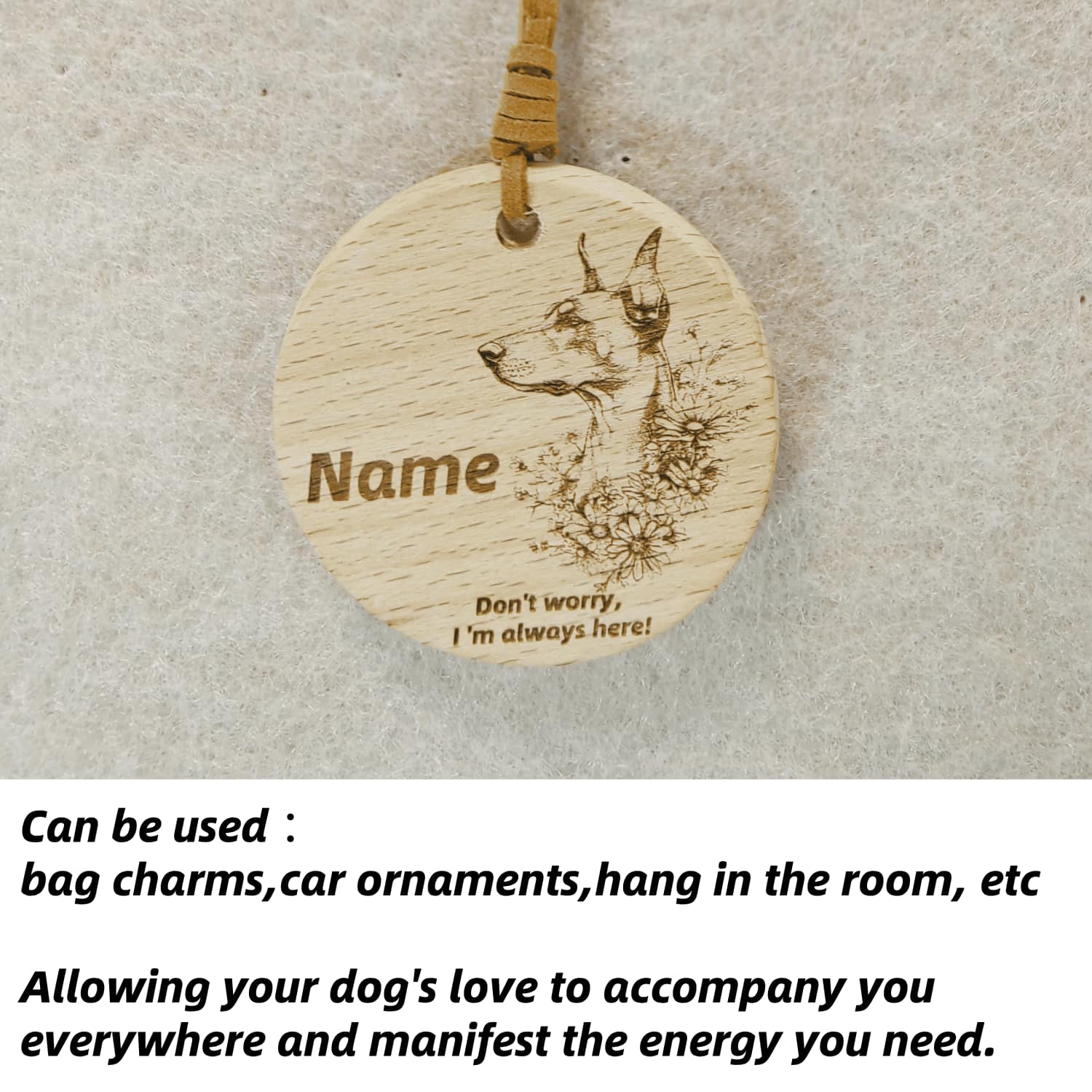 Doberman Pinscher wooden pendant used as a [car hang/bag charm] in a lifestyle setting.