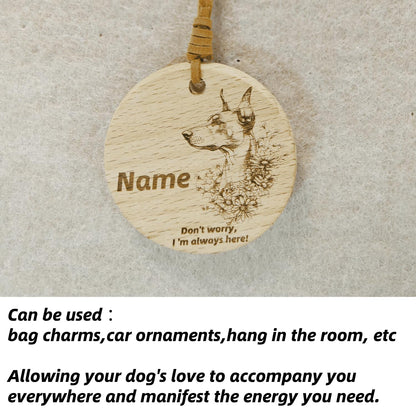 Doberman Pinscher wooden pendant used as a [car hang/bag charm] in a lifestyle setting.