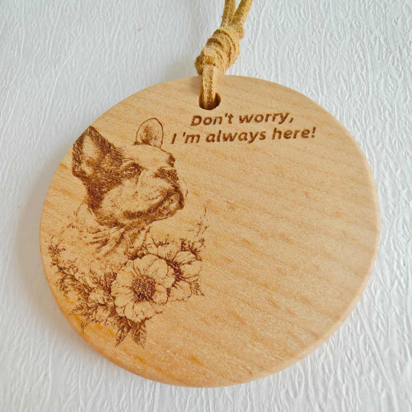 Close-up of the French Bulldog love design on the wooden pendant with inspirational quote.